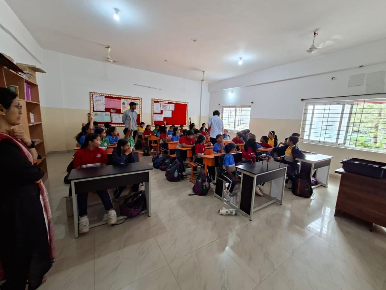 A classroom of students watching a robotics demo