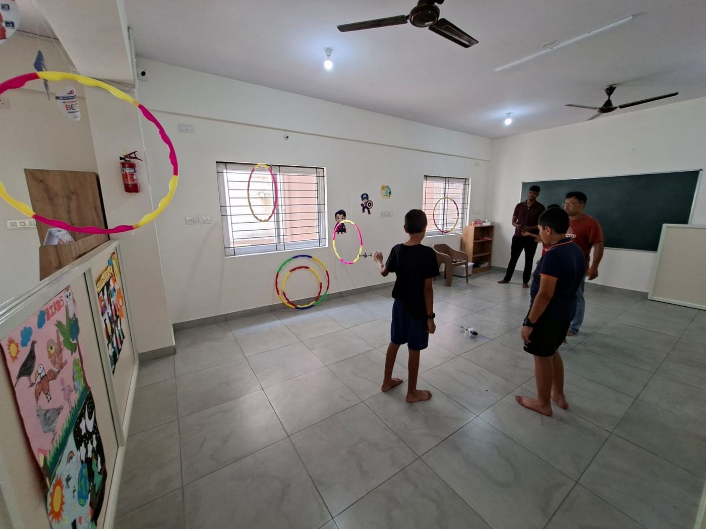 Students flying a mini drone through hoops in class