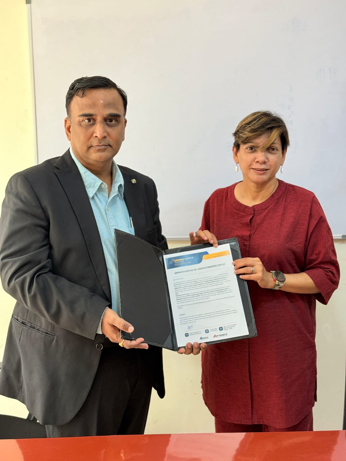 GNR Robotics and Dronacharya Tech Hub representatives holding the signed MOU